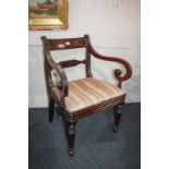 A Regency style mahogany bar back carver dining chair with scroll arms and upholstered drop-in seat,