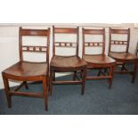 Four 19th century dining chairs with ball decorated bar backs and solid seats, on square tapered