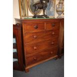 A George III mahogany chest of two short over three long drawers with dentil carved frieze, on