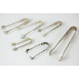 Four Victorian silver sugar tongs, a pair of American Lambert Brothers tongs marked Sterling, and