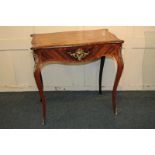 A French gilt metal mounted serpentine side table with cross banded top and single drawer, on