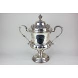 A George V silver trophy and cover, campana urn shape with two scroll handles and domed cover with