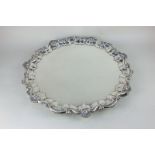 A large silver plated salver with cast scroll and shell border, on three scroll feet, 48cm