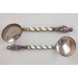 A pair of Victorian silver gilt serving spoons with terminals cast with allegorical figures