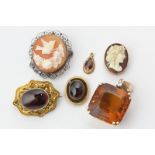 A large citrine pendant, a foil backed brooch in gold scroll mount, two shell cameos, and two garnet