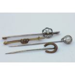An old cut diamond and pearl stick pin, a horseshoe stick pin, a Naval brooch, and a rose diamond