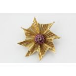An Italian 14ct yellow gold and ruby brooch of stylized flower head form, 15.6g gross