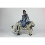 A Chinese glazed ceramic figure group, in the form of a sage atop an elephant, 33cm (a/f)