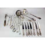 A collection of silver plated servers to include two soup ladles, a pair of salad servers, a stilton