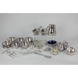 A set of six silver plated coasters with pierced sides, a three piece cruet set in the form of