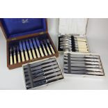 A cased set of six pairs of silver plated dessert knives and forks with engraved blades, in fitted