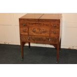 A George III mahogany dressing table with hinged divided rectangular top enclosing an easel toilet