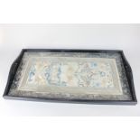 A rectangular wooden serving tray, with glass covered Chinese silk embroidered panel base, 67cm