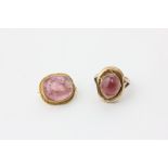 A cabochon ring, rubover set with a pale pink stone, and a cabochon brooch