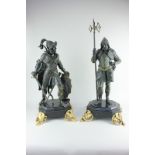 A pair of bronze medieval soldiers dressed in armour, each mounted on octagonal base with gilt metal