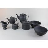 A collection of black basalt porcelain tea ware, to include two bowls, teapots, two milk jugs and