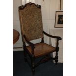 A Victorian scroll carved beech armchair with tapestry style upholstered back and cane seat, on