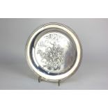 A modern silver circular dish with engraving of a horse drawn troika, signed Cuneo, maker Roberts