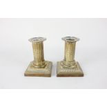 A pair of French brass column dwarf candlesticks, fluted stems cast with harebells, on square bases,