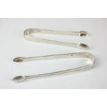 Two pairs of George III silver Old English pattern sugar tongs, one maker Solomon Hougham, London