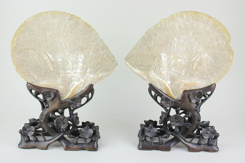 A pair of Chinese mother of pearl table screens, the shells carved with scenes of warriors