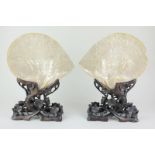 A pair of Chinese mother of pearl table screens, the shells carved with scenes of warriors