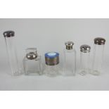 Six various silver topped glass dressing table jars, including one with a circular blue and white