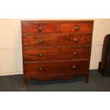 A George III mahogany chest of two short over three long drawers with brass lion mask knob