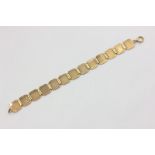 A 9ct gold bracelet with engine turned panels, 13.8g