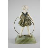 After Ferdinand Preiss, an Art Deco bronze and ivory figure, hoop girl, on green onyx base,