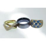 A seven stone sapphire ring in 9ct gold, a gilt metal ring, and a tungsten carbide ring
