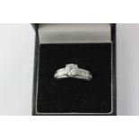 A diamond single stone ring, the round brilliant cut stone four-claw set above a pave set gallery,