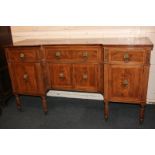 A George IV mahogany sideboard, the inverse break-front top above three frieze drawers over four
