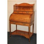 A Gillows 19th century satinwood and rosewood cylinder bureau, the waved shelf superstructure