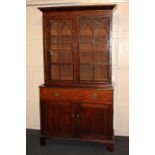 A Victorian mahogany bookcase with two panel glazed doors enclosing three adjustable shelves, the