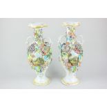 A pair of 19th century porcelain baluster vases depicting buildings in landscapes surrounded by