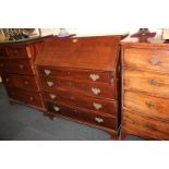 A George III mahogany bureau with fall enclosing fitted interior of drawers, pigeonholes, and