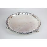 A modern silver salver with piecrust border, on three scroll feet, maker Viner's, Sheffield 1962,