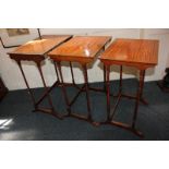An Edwardian inlaid mahogany nest of three tables, each with cross banded rectangular top, on turned
