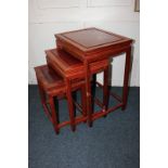 A Chinese hardwood nest of three side tables, each with rectangular top on square moulded legs