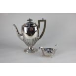 A Walker and Hall silver plated coffee pot, oval shape with demi fluting, on pedestal base, 27cm,