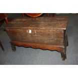 An oak six plank coffer, on later stand with wavy frieze and sloping block legs, 104cm (a/f)