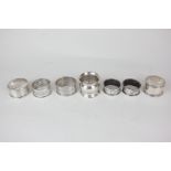 Seven silver napkin rings including a pair by William Adams Ltd, Birmingham 1915, 3.5oz