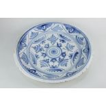 A Delft pottery charger in blue and white abstract floral design, 33.5cm diameter