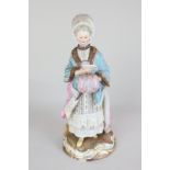 A Meissen porcelain figure of a woman in lace bonnet, reading a letter and holding a muff, crossed