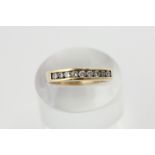 A diamond nine stone half hoop ring, channel set with uniform round stones in yellow gold
