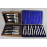 A set of six George V silver handled fruit knives and forks in fitted case, Sheffield 1910 and a