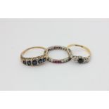 A ruby and white sapphire full hoop eternity ring, a sapphire and diamond ring, and a sapphire and