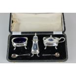 An Elizabeth II cased silver three piece cruet set of salt, pepper and mustard, with two cruet