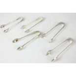 Five Edward VII silver sugar tongs including a matched pair with chased decoration, makers Joseph